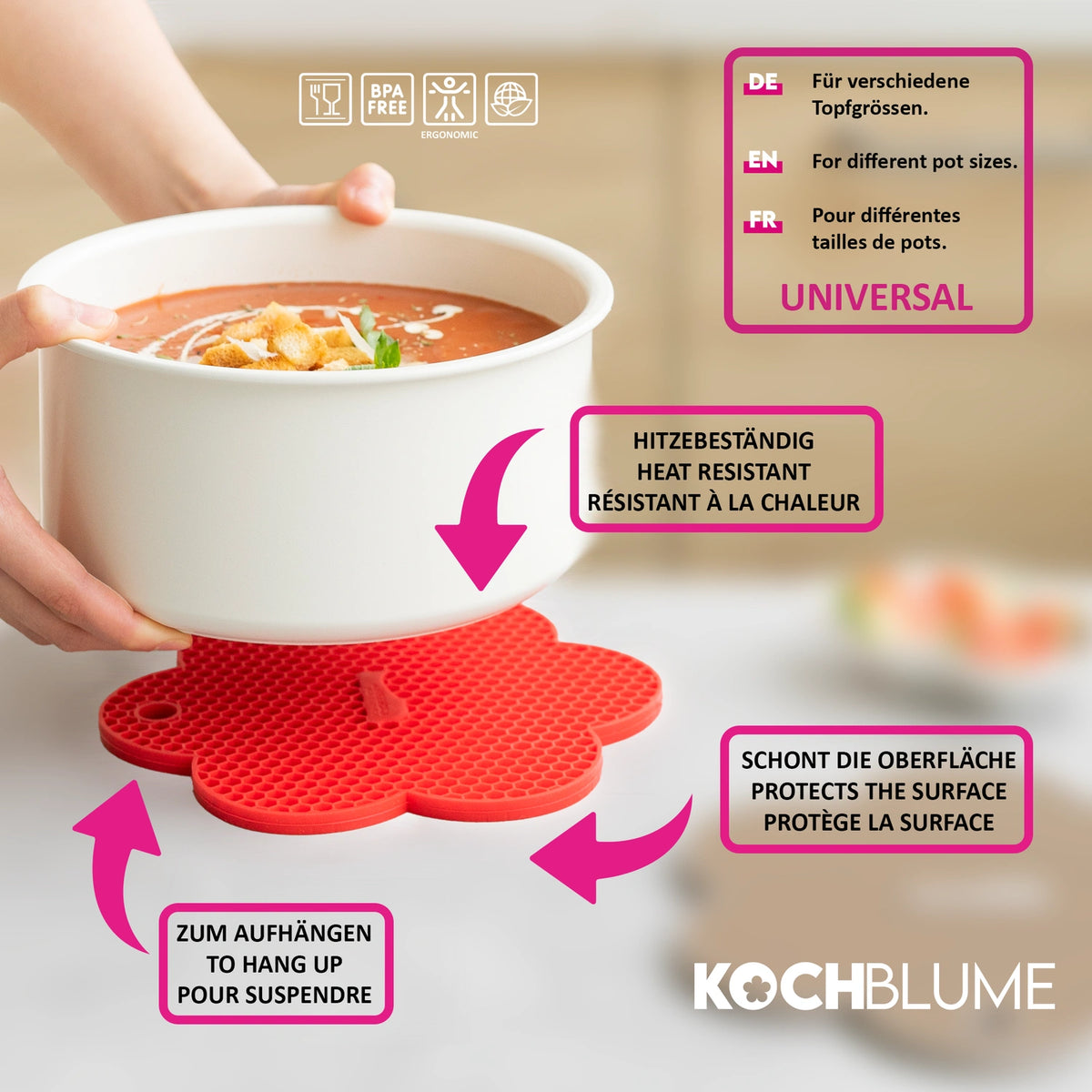 Eine Person hält eine Schüssel Suppe über einen Topfuntersetzer der Kochblume GmbH – einen roten, blumenförmigen Silikon-Topfuntersetzer – auf einem Holztisch, wobei jedes lebhafte Detail so präzise angeordnet ist wie die Hintergrundposition im CSS-Rahmendesign.