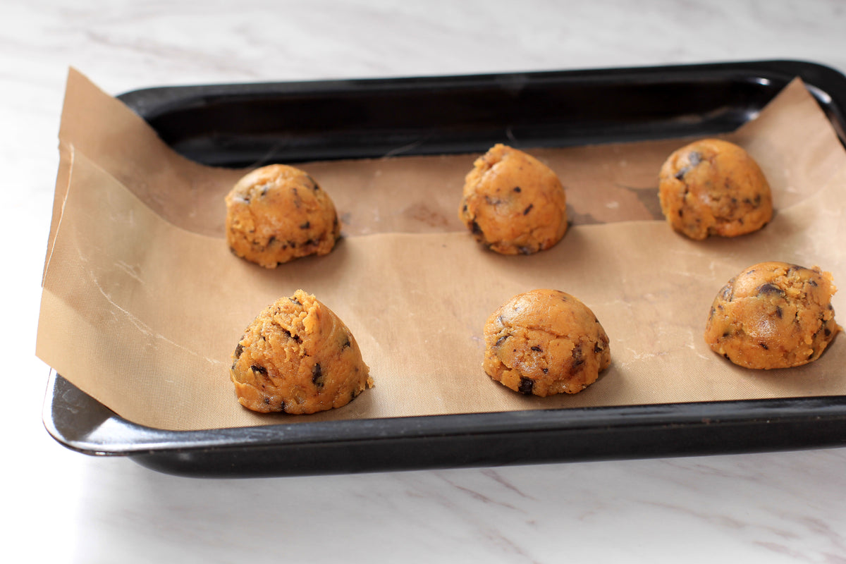 cookie-dough-balls-on-parchment-ready-for-baking
